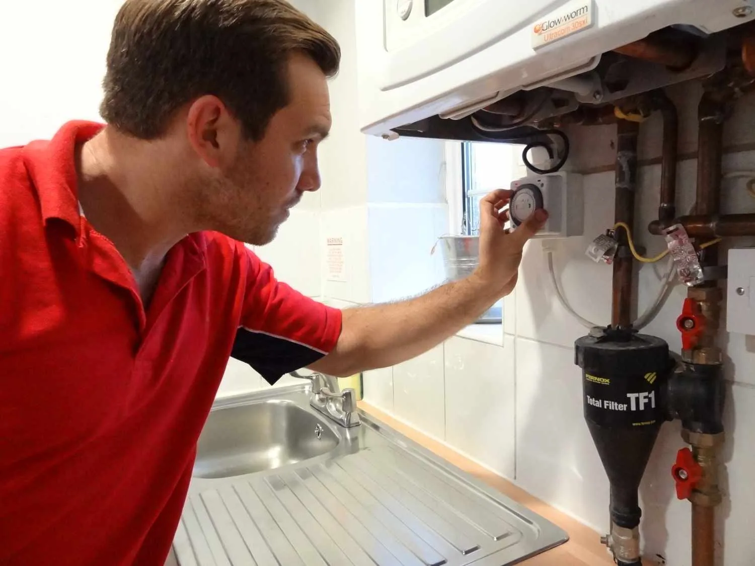 Walton Plumbers boiler repair engineer working on a boiler in Walton-on-Thames